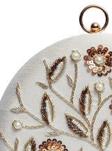 White round clutch purse with hand embroidery by The Tan Clan, featuring intricate details and a stylish design.