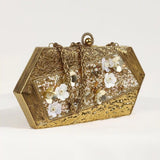 Gold brass clutch bag with intricate embellishments from The Tan Clan, featuring a stylish and elegant design.