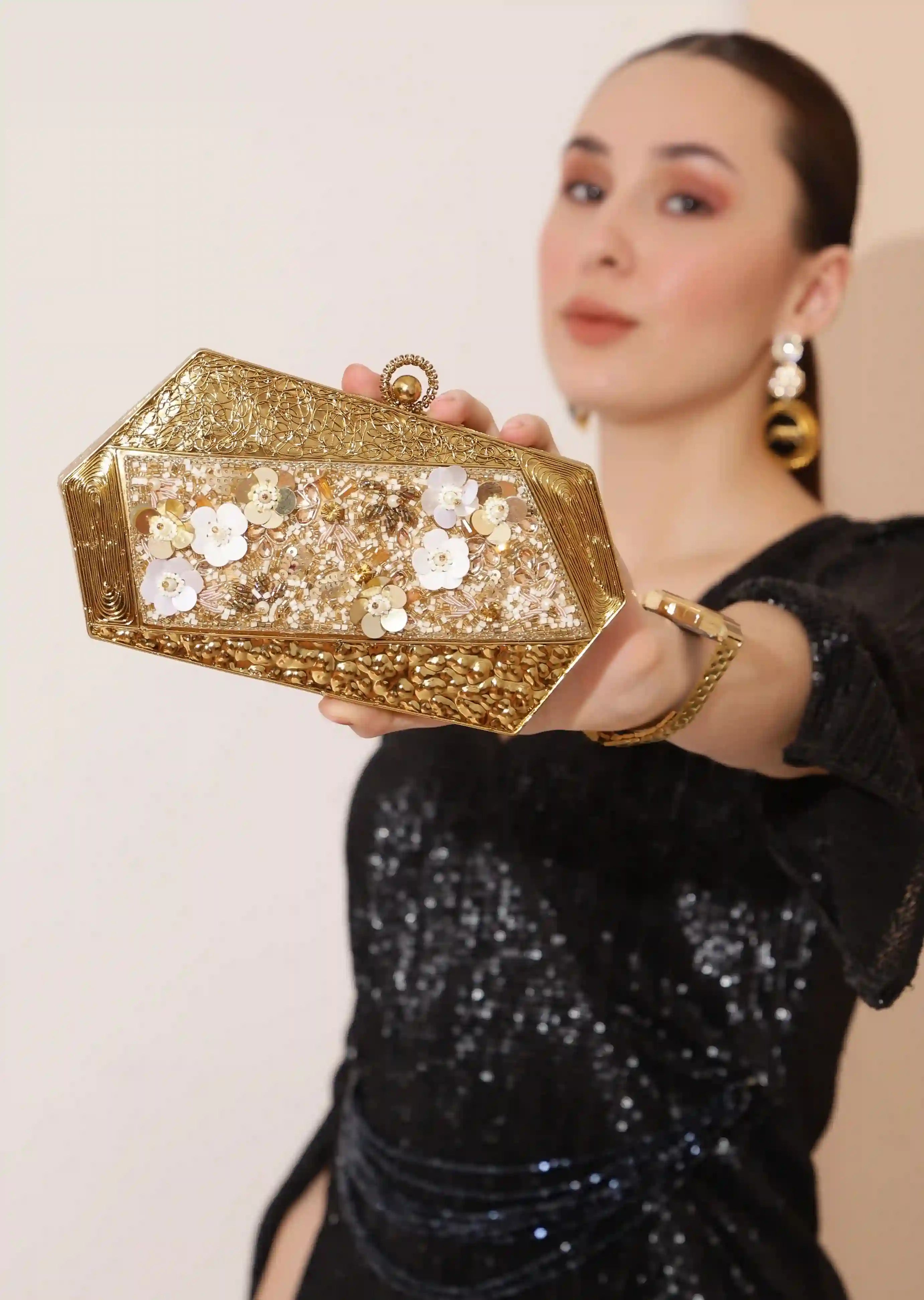Gold brass clutch with intricate embellishments and detailed craftsmanship, featuring the Fatima design by The Tan Clan.