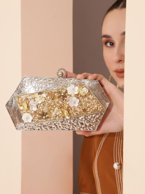 Silver embellished brass clutch bag with intricate details, designed by The Tan Clan for elegant evening wear.