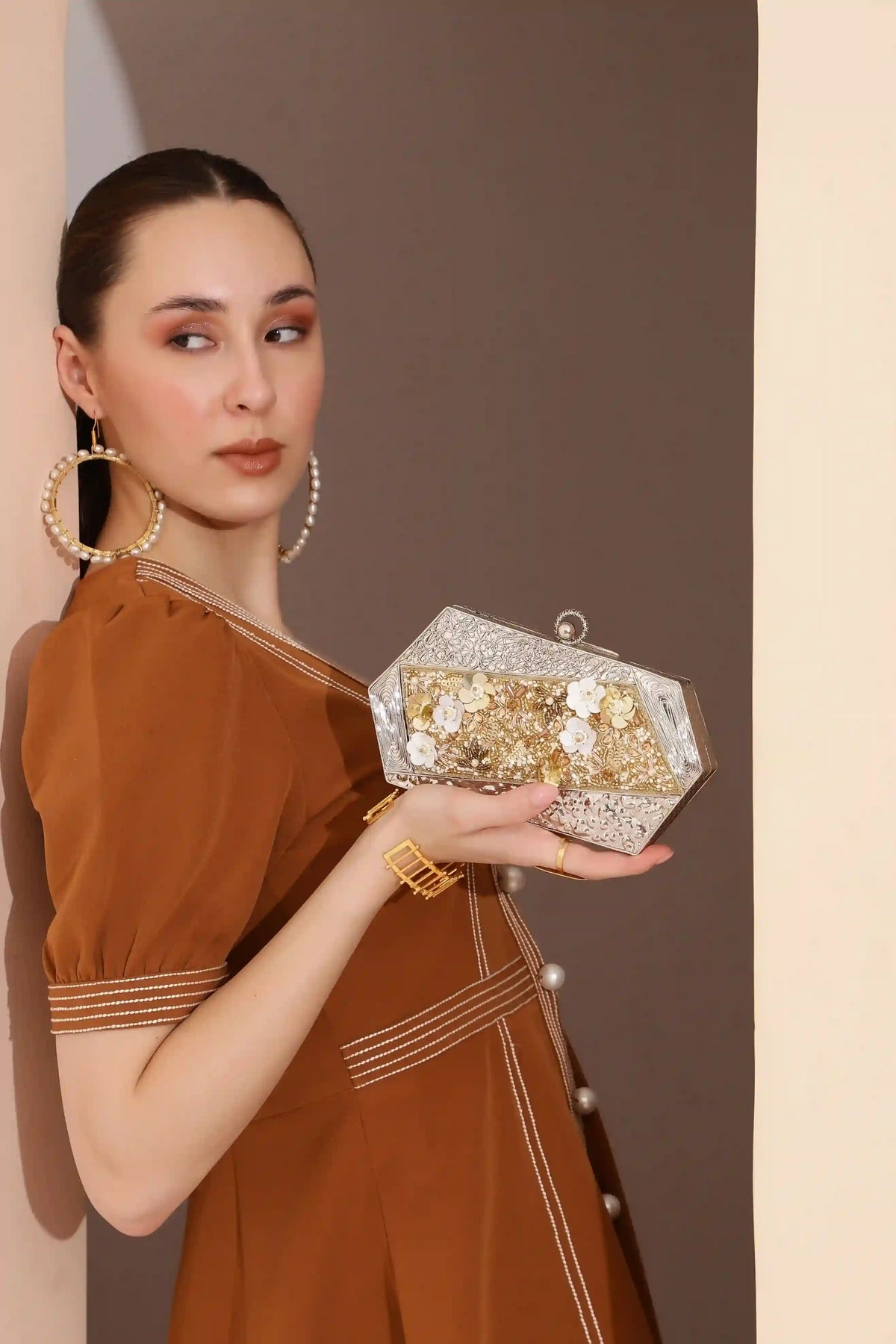 Silver embellished brass clutch bag with intricate designs, from The Tan Clan's Fatima collection.