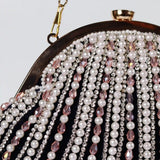 Black Frida Batua Bag by The Tan Clan with a detachable handle, shown with stylish design and versatile carrying options.
