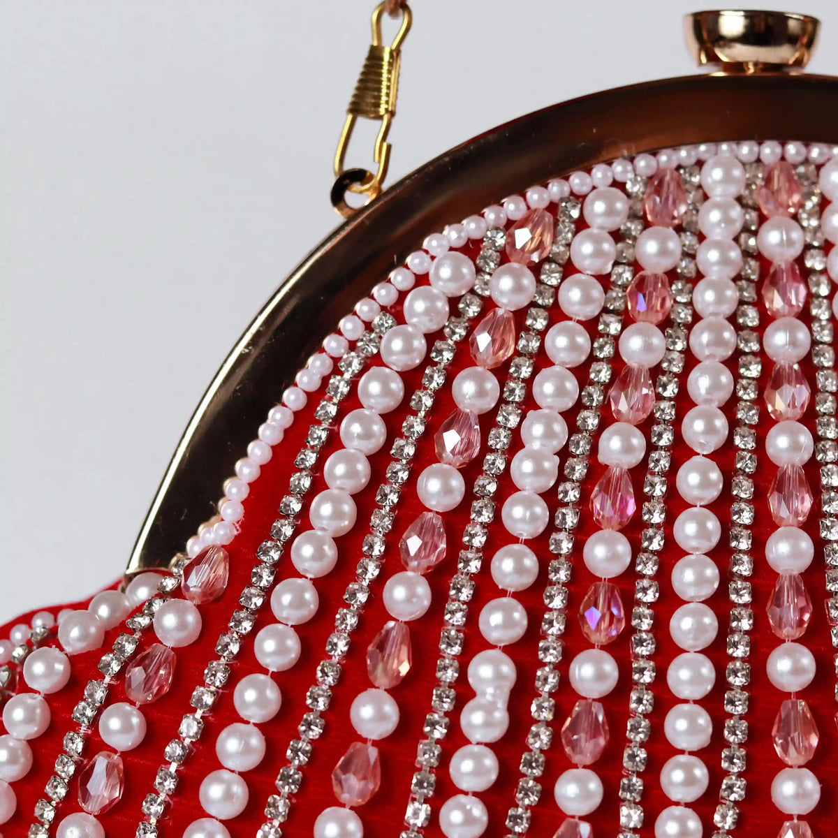 Red Frida Batua Bag by The Tan Clan with detachable handle, showcasing its stylish design and versatile carrying options.