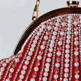 Red Frida Batua Bag by The Tan Clan with detachable handle, showcasing its stylish design and versatile carrying options.
