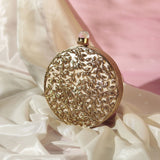 Intricate brass work with mother of pearl clutch by The Tan Clan, showcasing detailed craftsmanship and elegant design.