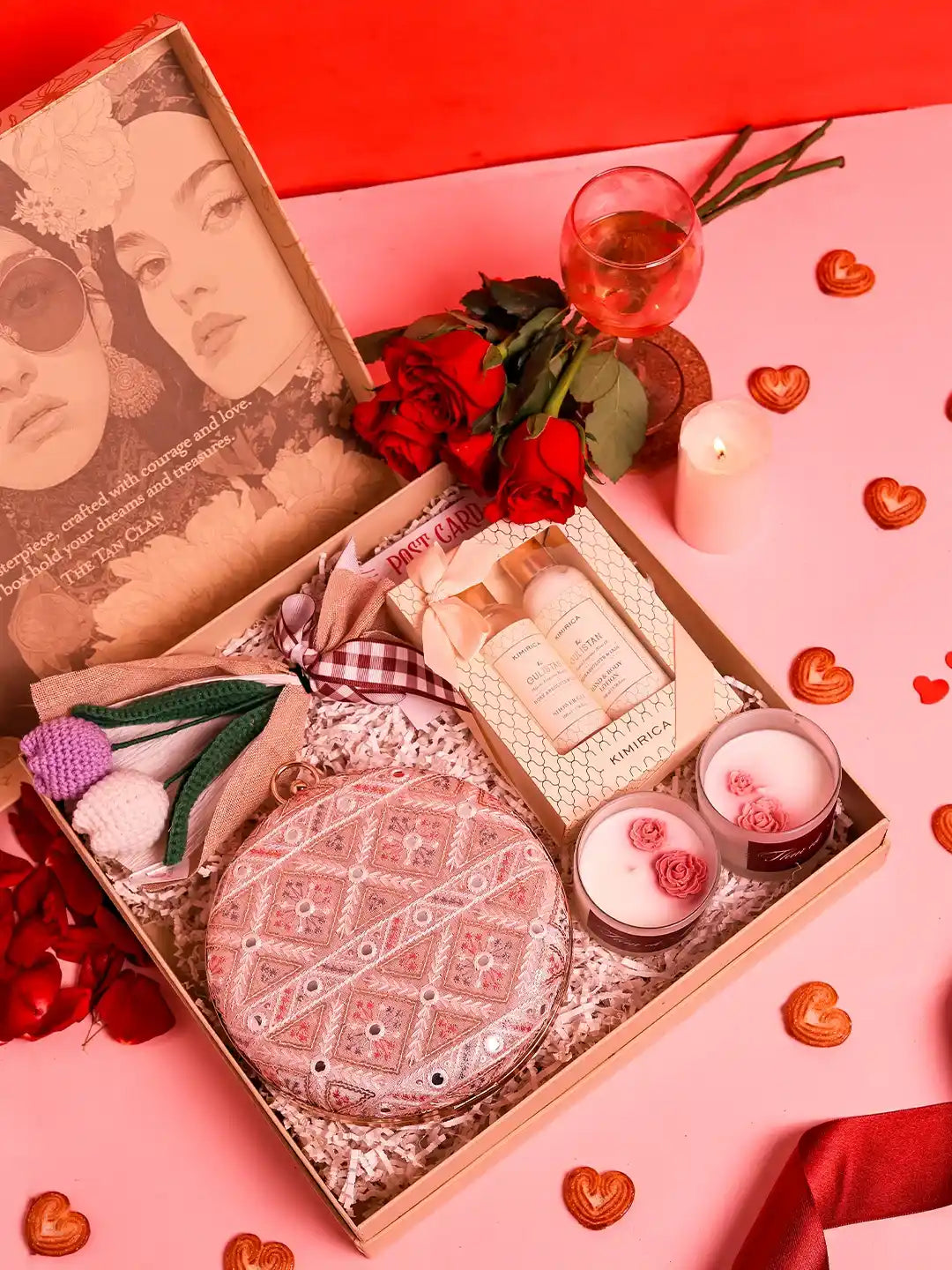 Premium gift set from THE TAN CLAN featuring four items and a stylish clutch in a sleek box.