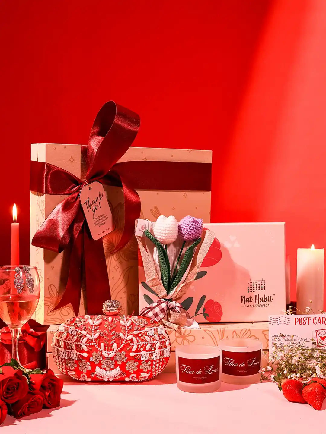 Premium gift set from THE TAN CLAN featuring a box of 8 items and a stylish clutch bag, perfect for gifting occasions.