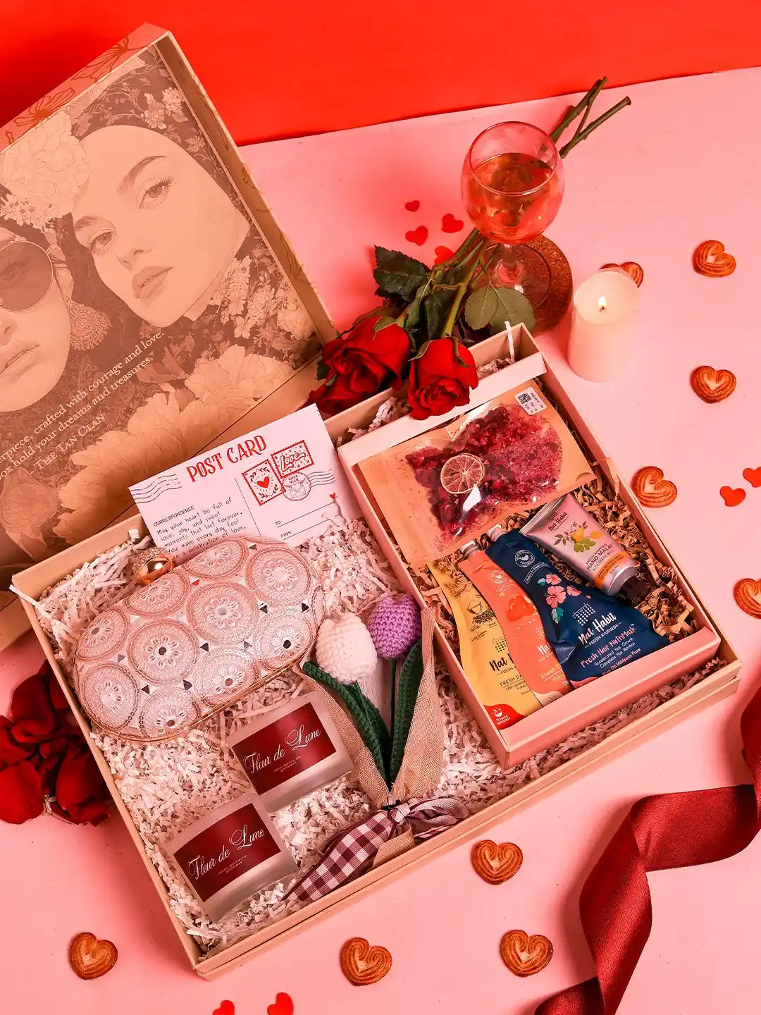Premium gift set by THE TAN CLAN featuring 8 items and a stylish clutch in a sleek box arrangement.