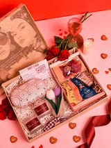 Premium gift set by THE TAN CLAN featuring 8 items and a stylish clutch in a sleek box arrangement.