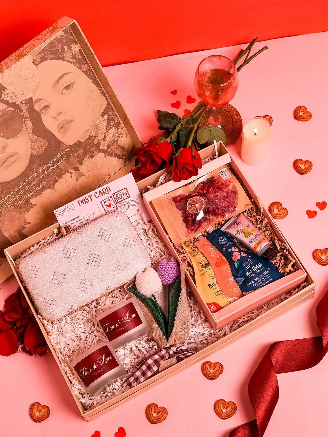 Premium gift set by THE TAN CLAN featuring a box of 8 items and a stylish clutch bag, perfect for gifting occasions.