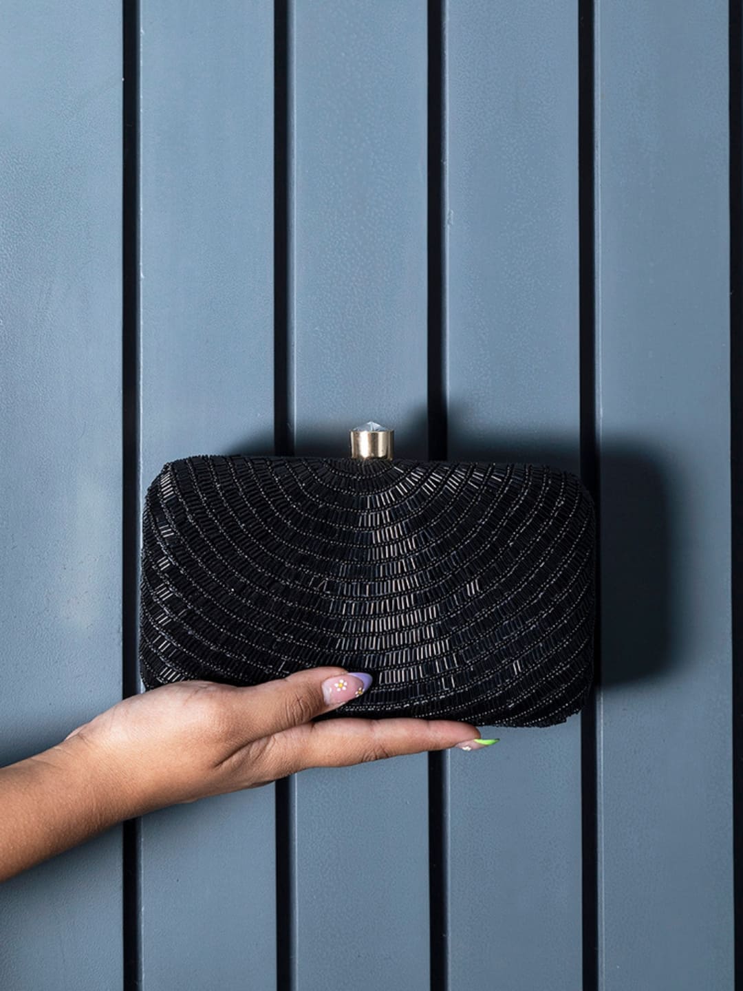 Black hand-embroidered party clutch by The Tan Clan featuring intricate beadwork and elegant design for special occasions.