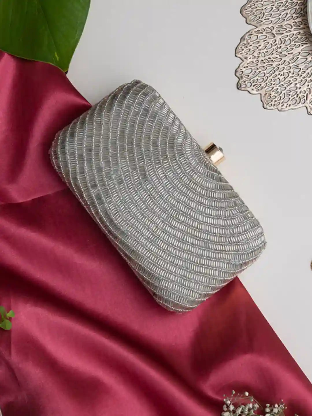 Silver hand-embroidered party clutch with beige flap, featuring intricate glittering details, by The Tan Clan.