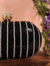 Black sequins oval clutch by The Tan Clan featuring a shimmering glow design, ideal for elegant evening occasions.