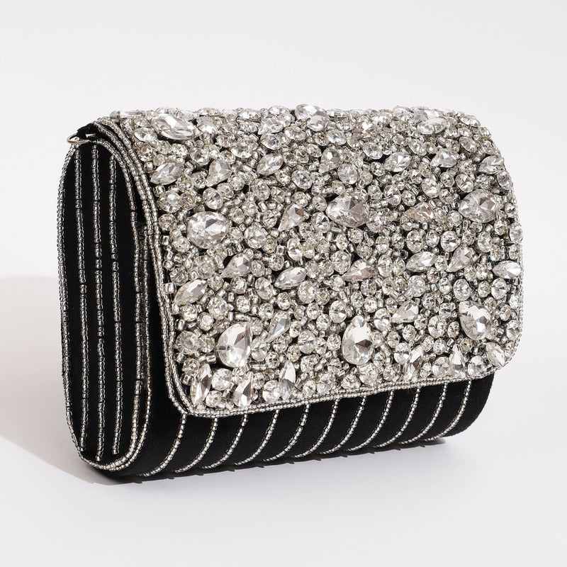 Black Grace embellished flap-over bag by The Tan Clan showing a stylish bag with decorative embellishments and a flap closure.