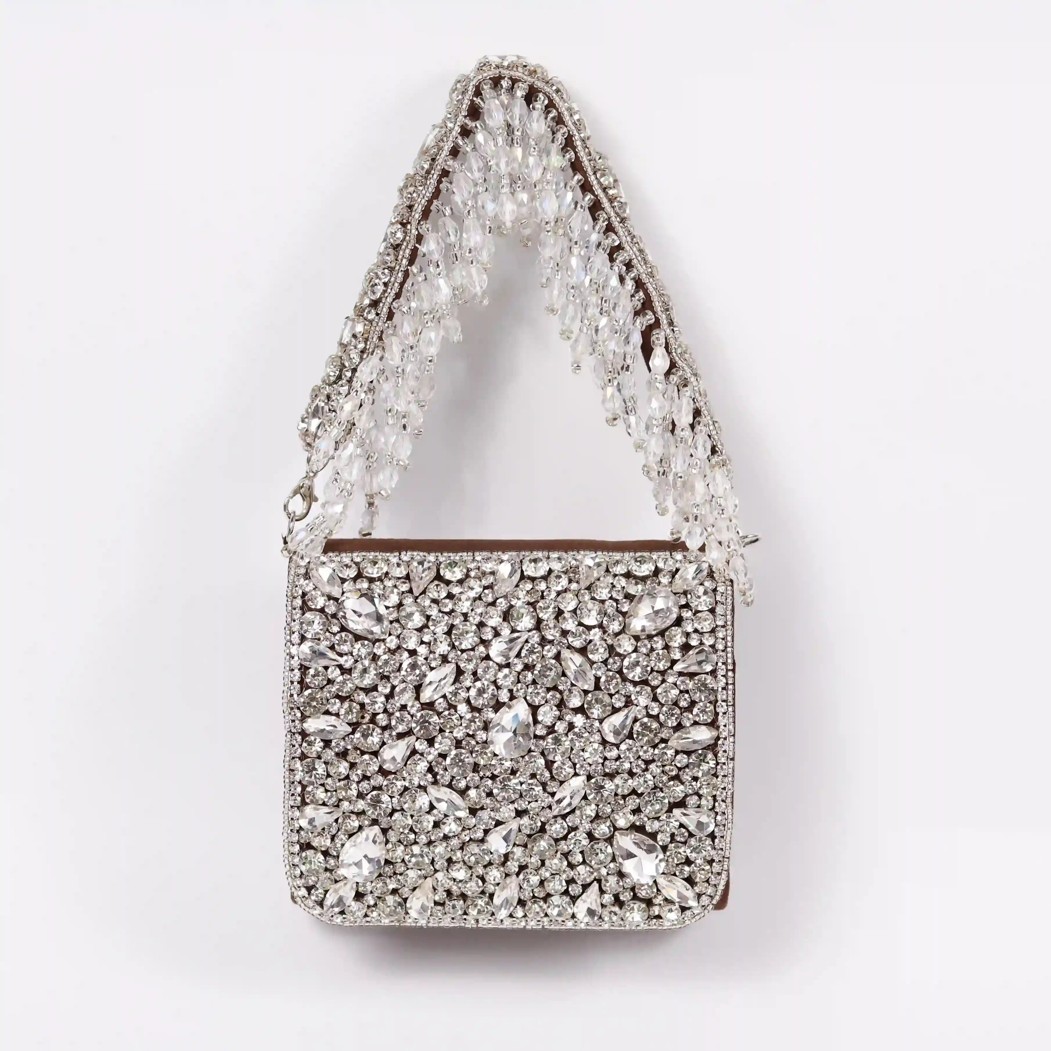 Brown Grace mini bag with embroidered handle by The Tan Clan, featuring a sleek design and detailed stitching.