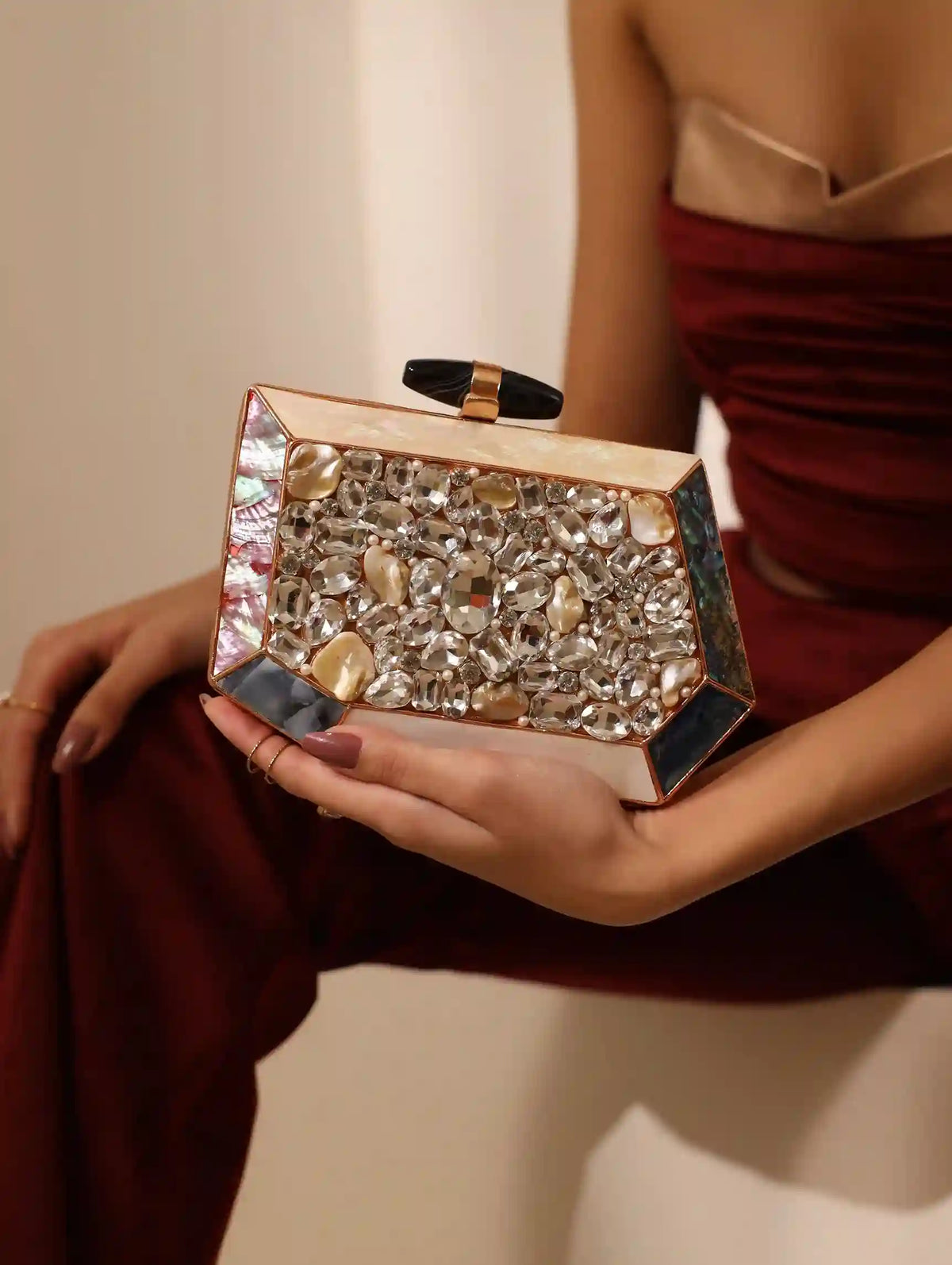 Hannah embellished mother of pearl clutch from The Tan Clan featuring intricate beadwork and a sleek, elegant design.