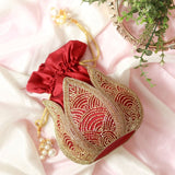 Hand-embroidered mini lotus potli bag by The Tan Clan with intricate floral embroidery and traditional drawstring closure.
