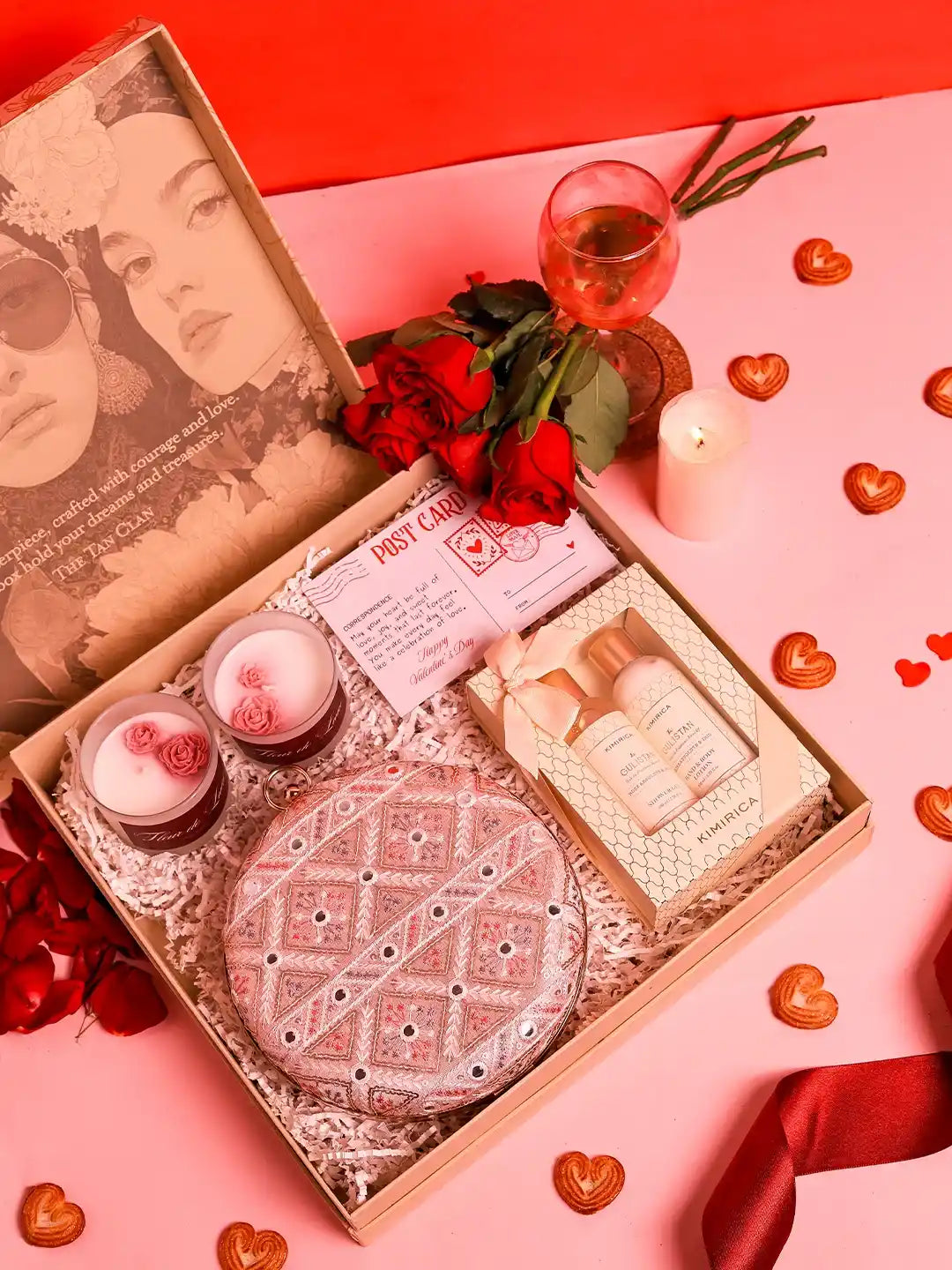 Her Pamper Hamper set featuring an Ariba clutch, a candle, and three Kimirica skincare products from THE TAN CLAN.