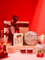 Her Pamper Hamper from THE TAN CLAN including a Jashn clutch, candle, and Kimirica set of 3, displayed with elegant packaging.