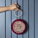 Maroon round clutch bag with intricate hand embroidery by The Tan Clan, stylish accessory for special occasions.