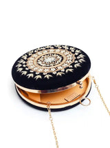 Round hand-embroidered clutch bag by The Tan Clan featuring intricate embroidery and a soft fabric exterior.