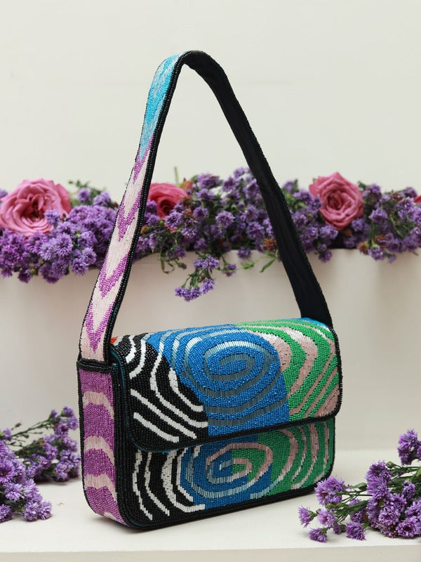 The Tan Clan Iris Baguette Bag with handle, stylish woven design, compact size, and versatile for daily use.