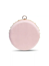 Round hand-embroidered clutch by The Tan Clan with tassels, featuring intricate embroidery and a stylish design.