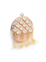 Round hand-embroidered clutch bag with tassels by The Tan Clan, featuring colorful embroidery and a compact design.