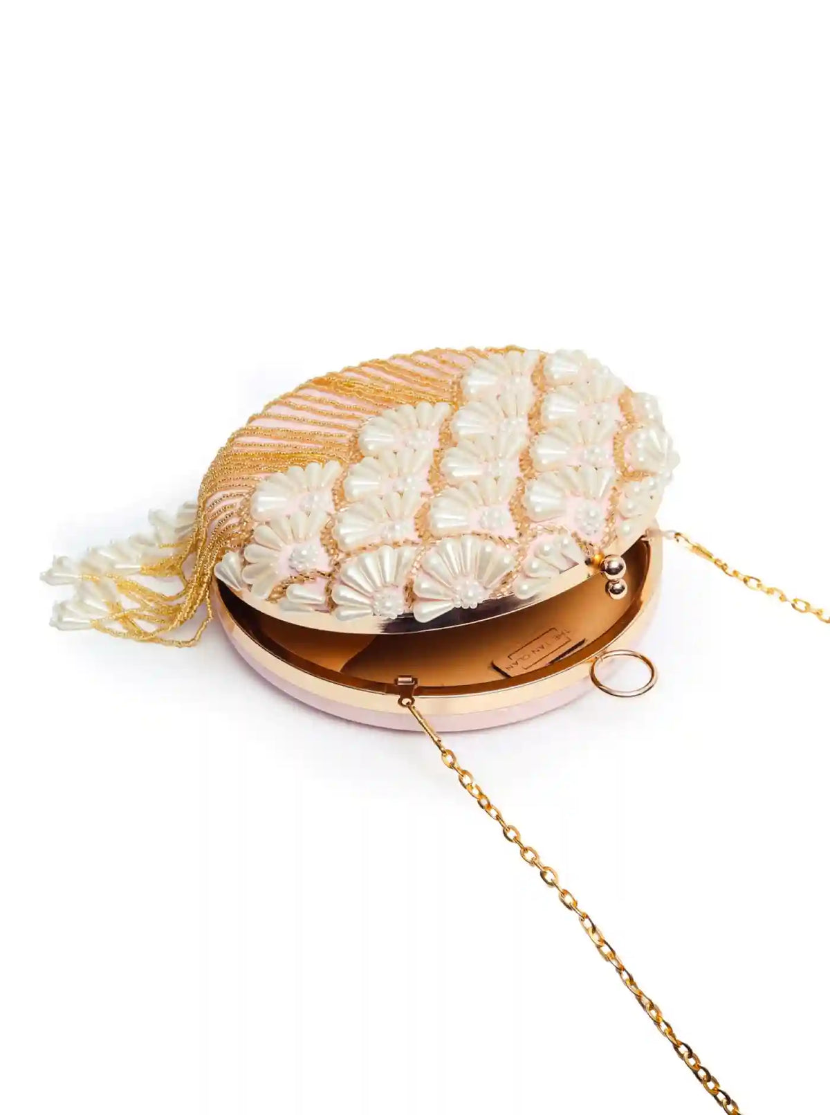 Close-up of Irsa round hand-embroidered clutch from The Tan Clan with tassels, showcasing detailed embroidery and elegant design.