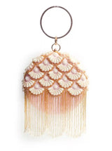 Round hand-embroidered clutch with tassels by The Tan Clan, featuring intricate embroidery and stylish design for elegant occasions.