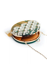 Round hand-embroidered clutch with tassels by The Tan Clan, featuring intricate embroidery and stylish tassel accents.