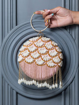 Round hand-embroidered clutch bag with tassels by The Tan Clan featuring intricate embroidery and a stylish design.