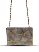 Isa Mother of Pearl Clutch by The Tan Clan featuring a shimmering mother of pearl exterior and sleek design.