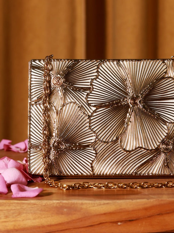 Isa Mother of Pearl Clutch by The Tan Clan showing a shimmering pearl-toned evening bag with a sleek design and metallic clasp.