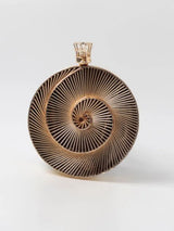 Intricate brass wirework clutch bag by The Tan Clan featuring detailed craftsmanship and elegant design.