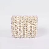 Jade mini bag by The Tan Clan with embroidered handle, featuring a compact design and detailed embroidery on the handle.