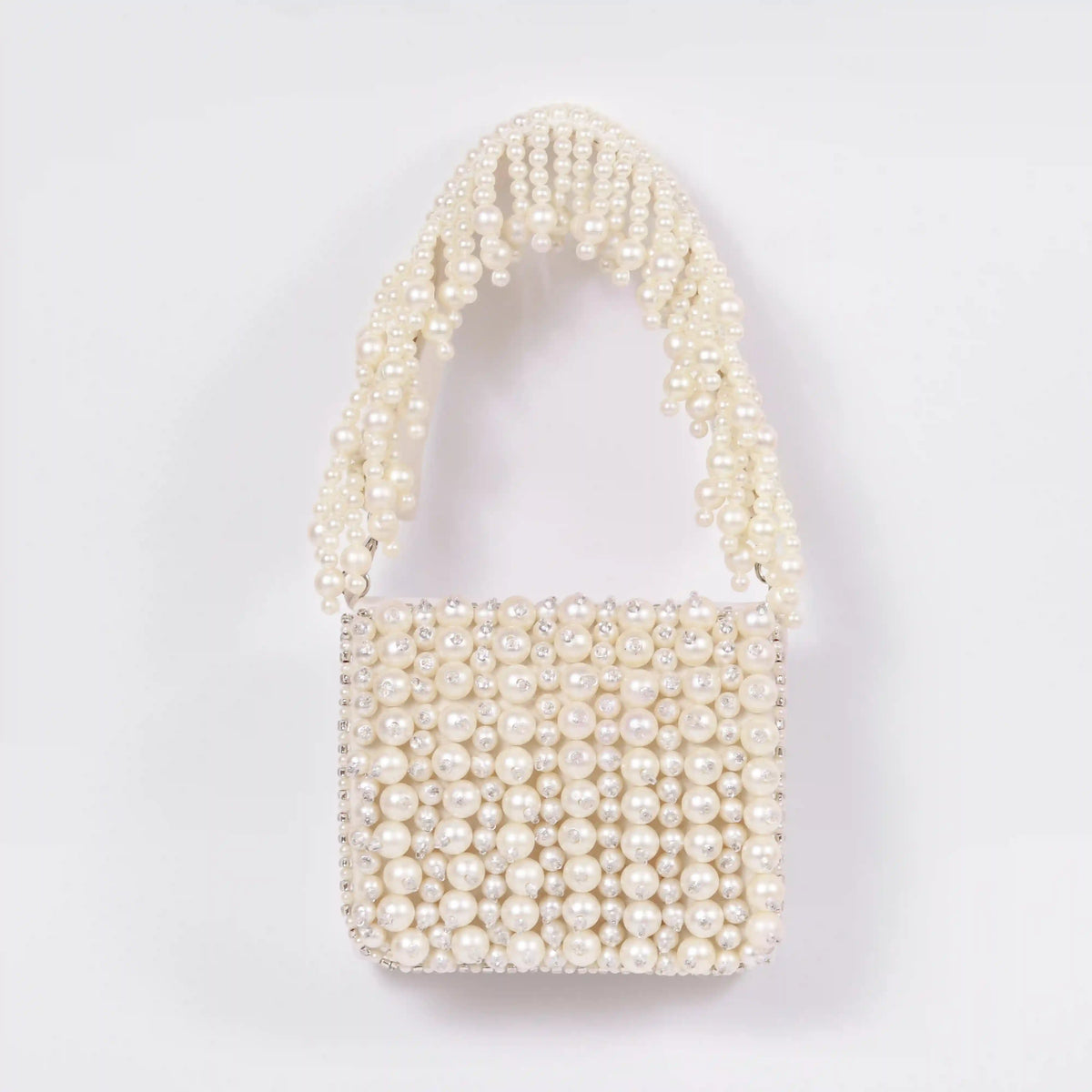 Jade mini bag from The Tan Clan with embroidered handle, featuring a compact design and detailed embroidery on the strap.