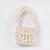 Jade mini bag from The Tan Clan with embroidered handle, featuring a compact design and detailed embroidery on the strap.