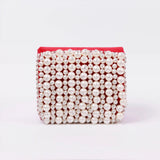 Jade mini bag by The Tan Clan with embroidered handle, featuring a compact design and detailed embroidery on the strap.