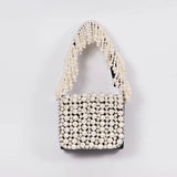 Jade mini bag by The Tan Clan featuring an embroidered handle and sleek design, perfect for stylish accessories.