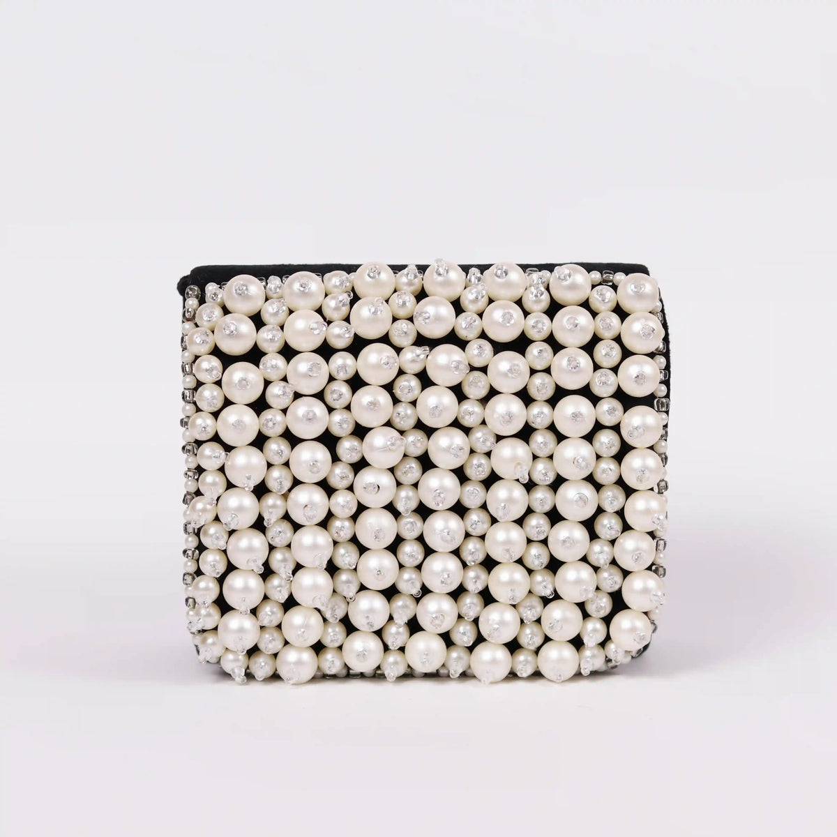 Jade mini bag by The Tan Clan with embroidered handle, featuring a compact design and detailed stitching on the handle.
