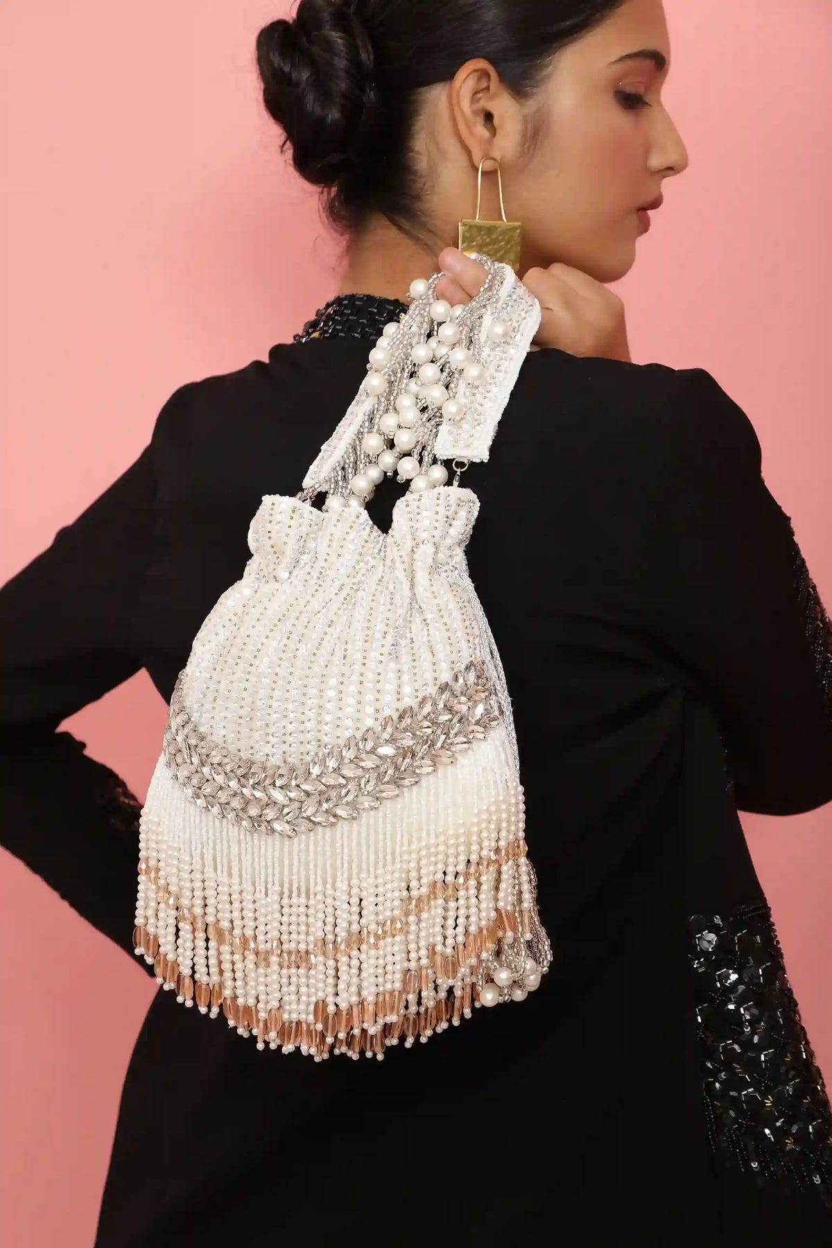 Elegant Jalsa Potli Bag with Handle by The Tan Clan, featuring intricate fabric design and a convenient carrying handle.