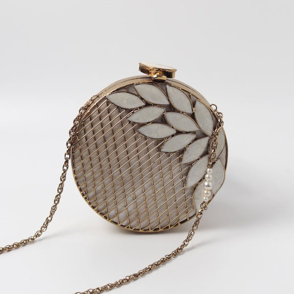 Jannat brass clutch with intricate brass work and mother of pearl detailing, featuring a decorative clasp and elegant design.