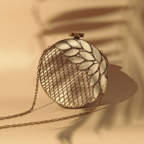 Intricate brass work with mother of pearl on a stylish clutch bag from The Tan Clan, showcasing detailed craftsmanship and elegant design.