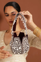 Jhalak potli bag with handle by The Tan Clan, featuring traditional embroidery and tassel detailing for festive occasions.