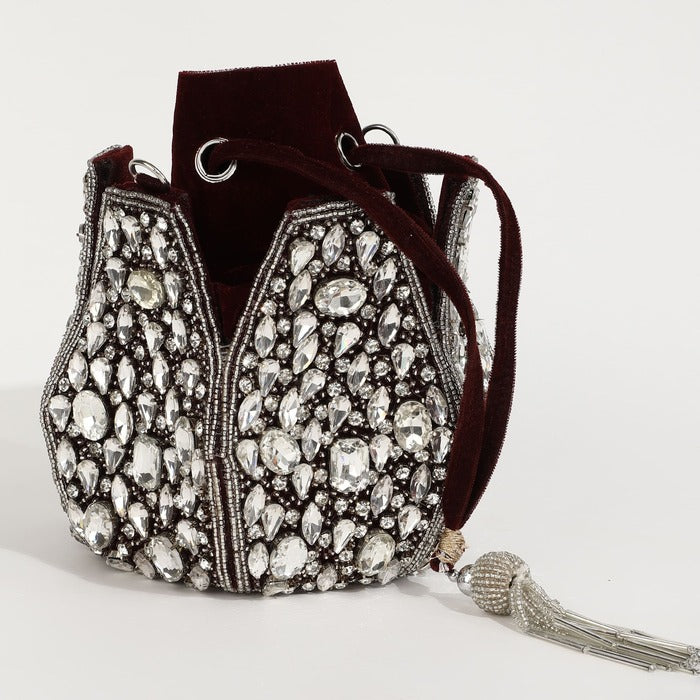 Tan Clan Jhalak Potli Bag with Handle featuring intricate embroidery and a traditional design for elegant occasions.