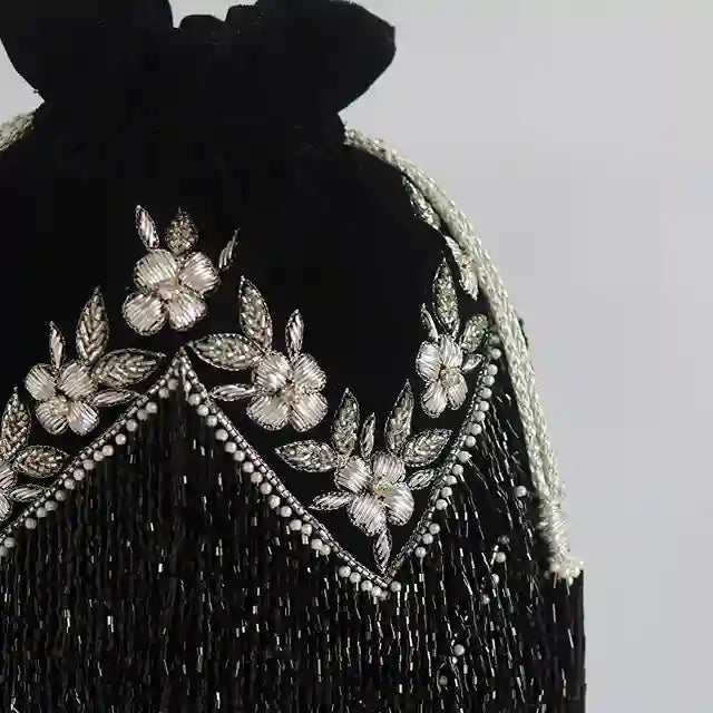 Black tassel potli bag with handle from The Tan Clan, featuring intricate design and traditional Indian craftsmanship.