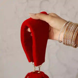 Red bridal Zardozi embroidered potli bag with intricate gold threadwork, traditional Indian accessory by The Tan Clan.