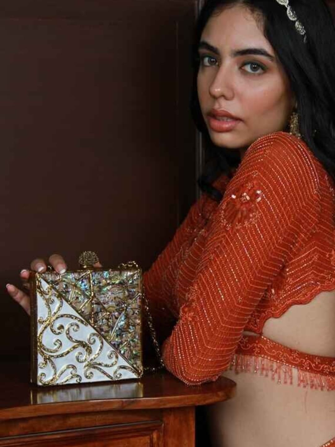 Lihaaz Mother of Pearl brass clutch by The Tan Clan featuring intricate pearl and brass design on a sleek, elegant evening bag