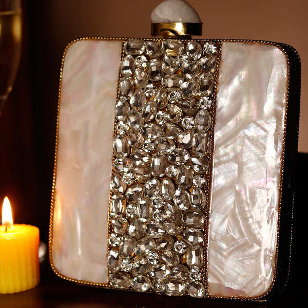Liyana Mother of Pearl Clutch by The Tan Clan featuring shimmering pearl details and a sleek, elegant design.